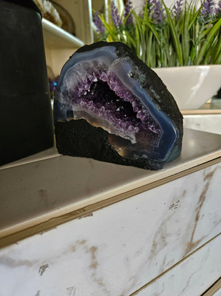 Amethyst Geode with on a marble surface

CHIQUE Rock Shop 
